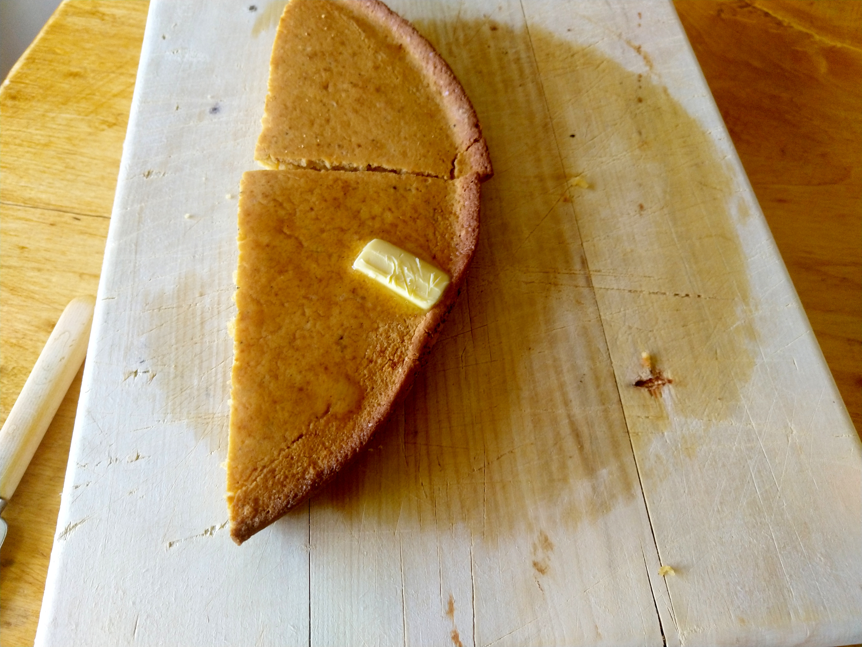 Steaming-hot, soft cornbread, slumbering contentedly on a chopping board.  A lazy dollop of butter melts upon the brown crust.  In the distance, trumpets.