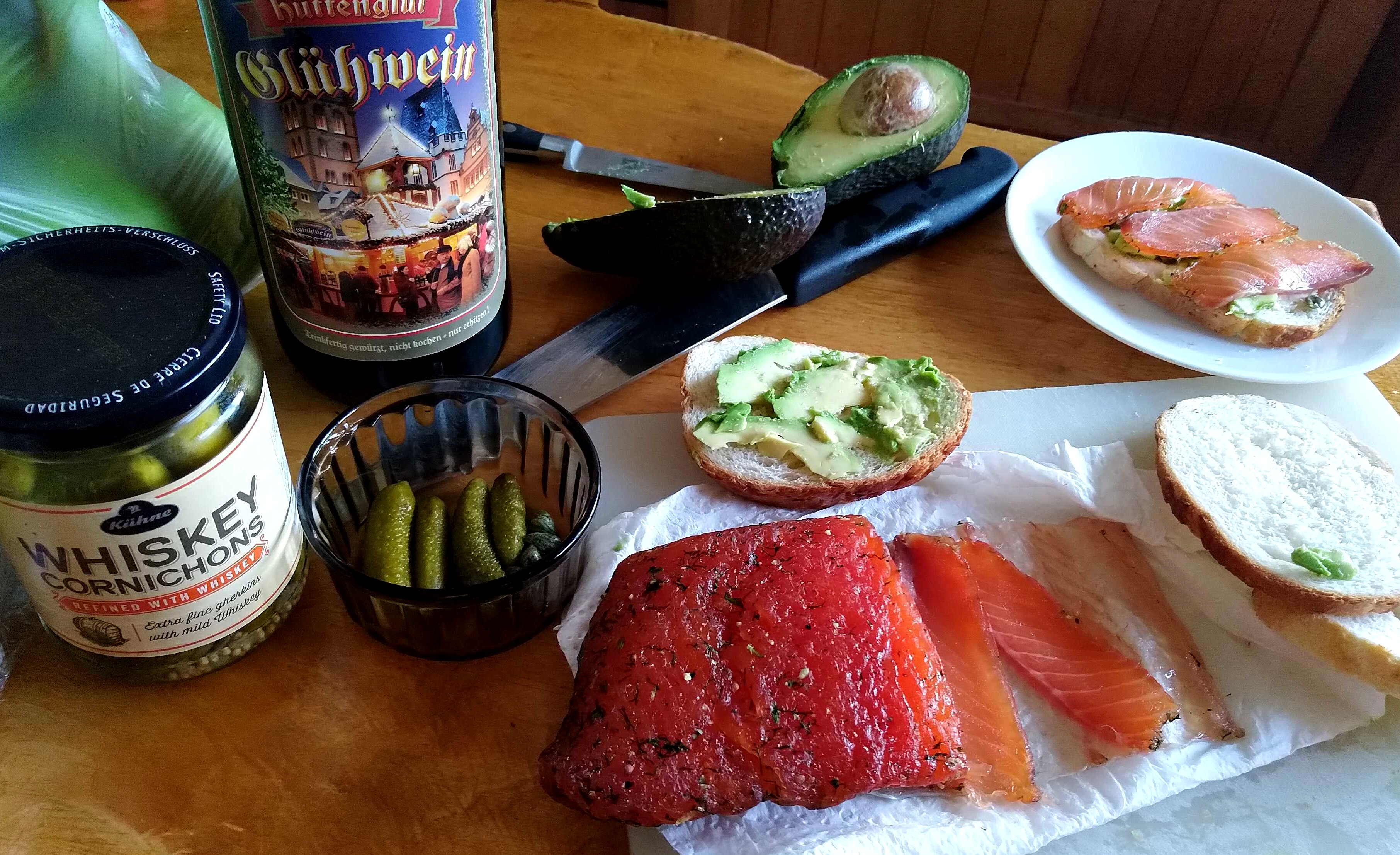 Action shot!  Thinly-sliced salmon gravlax, whisky-cured pickled gherkins, avocado toast, and mulled wine.