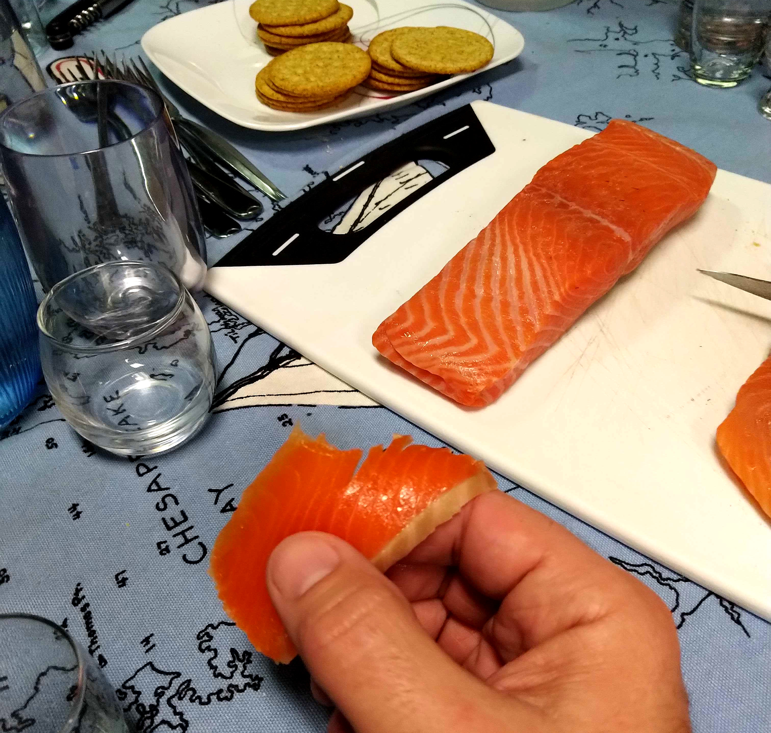 My hand, holding a slice of gravlax salmon which was way too thick.
