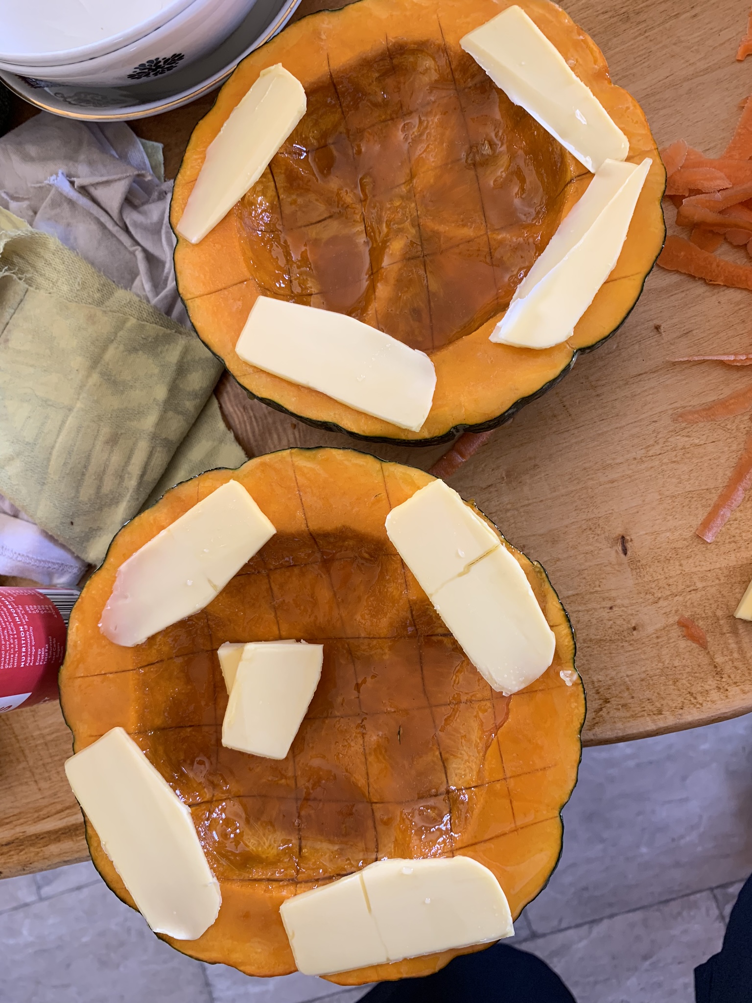 Pre-cooking pumpkin.  Cut in half like a couple bowls, honey rubbed all over, and butter slices arranged around the rim and inside.
