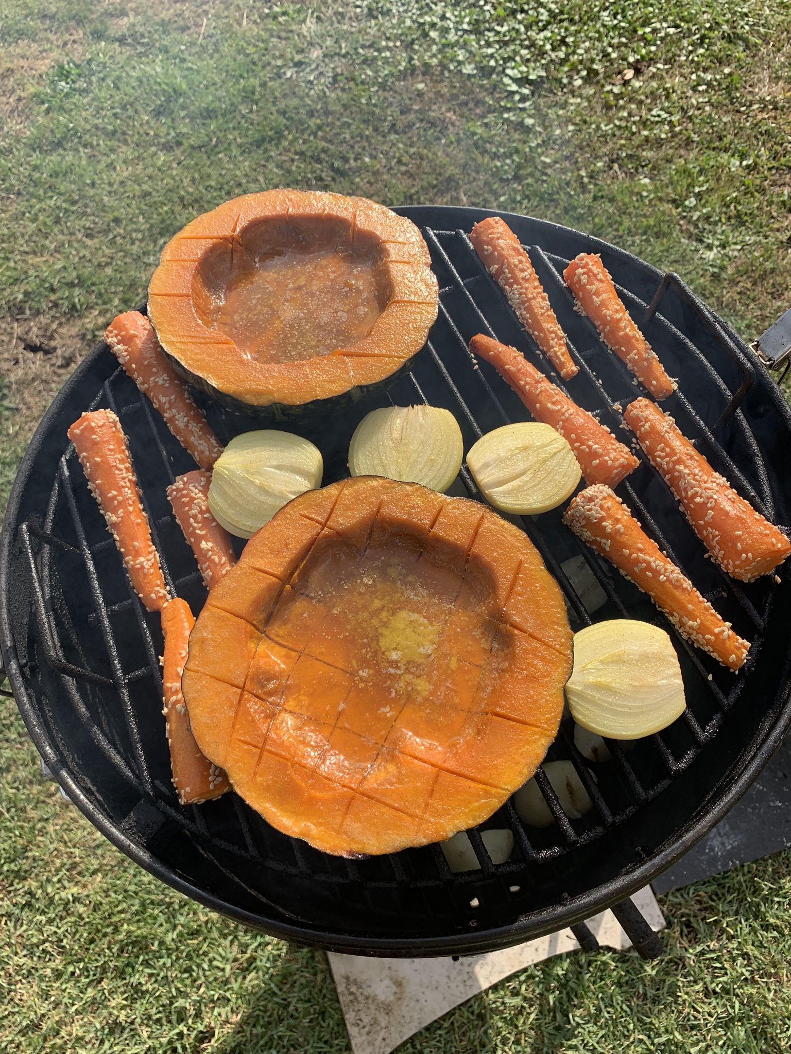 The smoker with pumpkins, carrots, and onions.  Pumpkins are a rich orange.  All the butter has melted and flowed into the bowl.