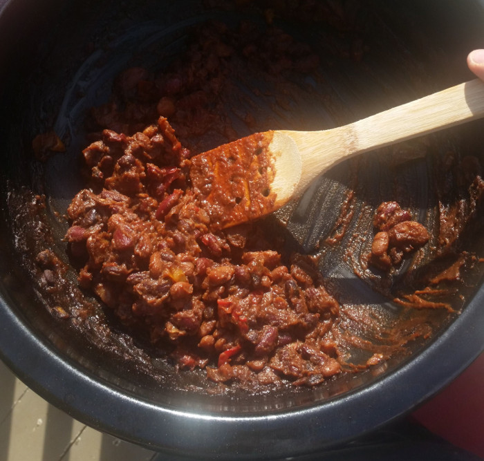 The liquid has thickened into a paste consistency; the beans are way softer, many are mashed and split. The capsicum peeks through in splashes of colour.