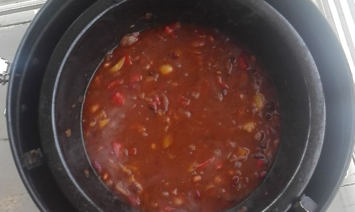 The beans simmering - it's all still very liquid, all the beans are still firm and bean-shaped, and chunks of capsicum and onion are recognisable.