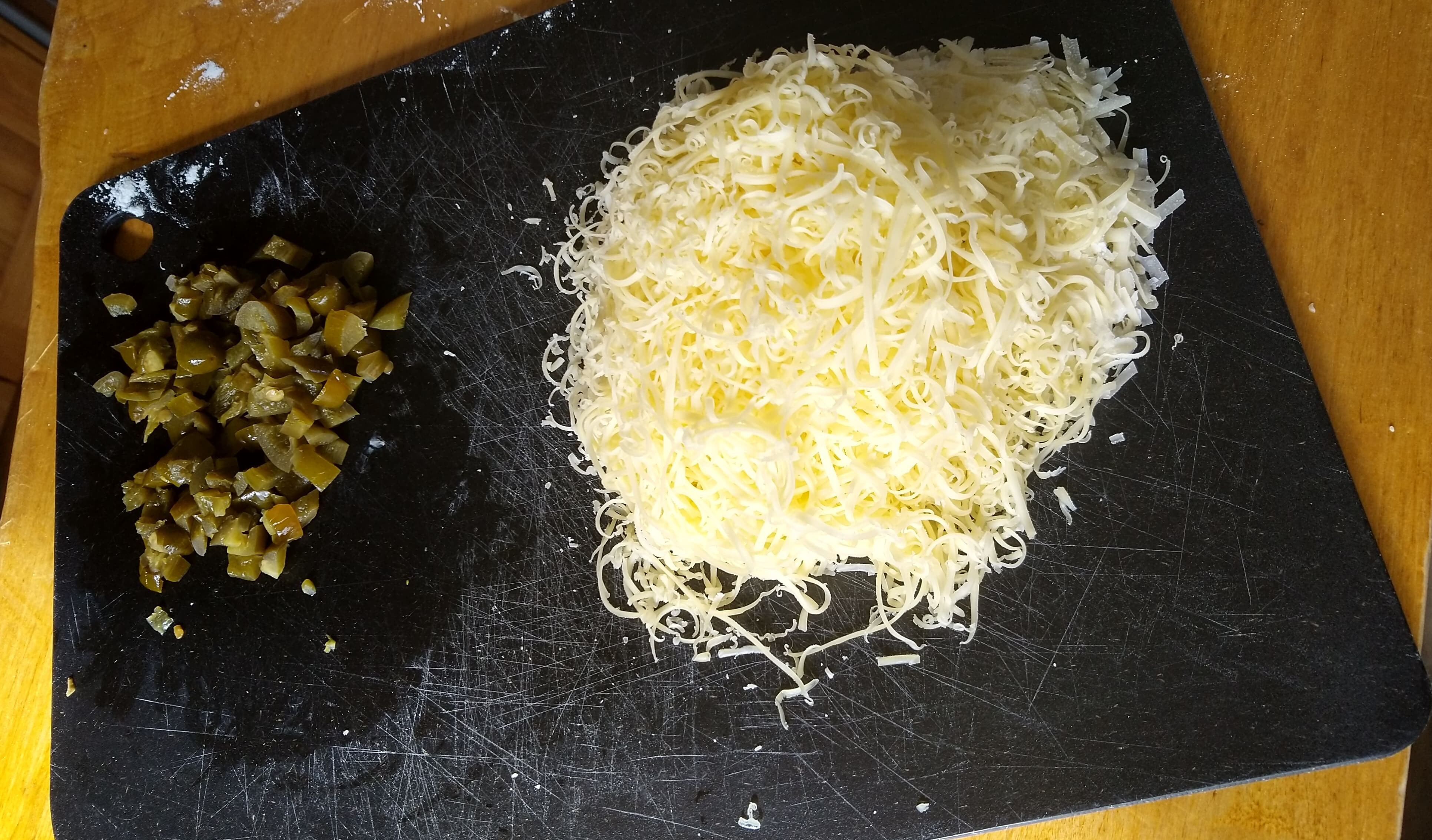 The cheese and jalapeño ready for the pan! The jalapeño and cheese on the chopping board, ready to be introduced to the batter