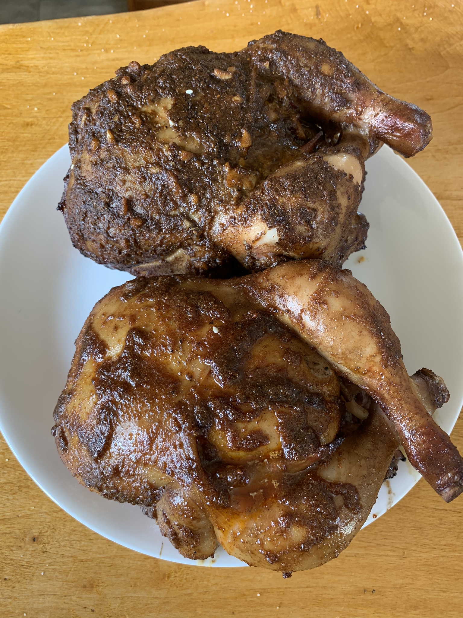 Post-cooked chicken. It’s dark and smokey, still clearly moist. It’s difficult to tell the difference, but one has visible garlic chunks.