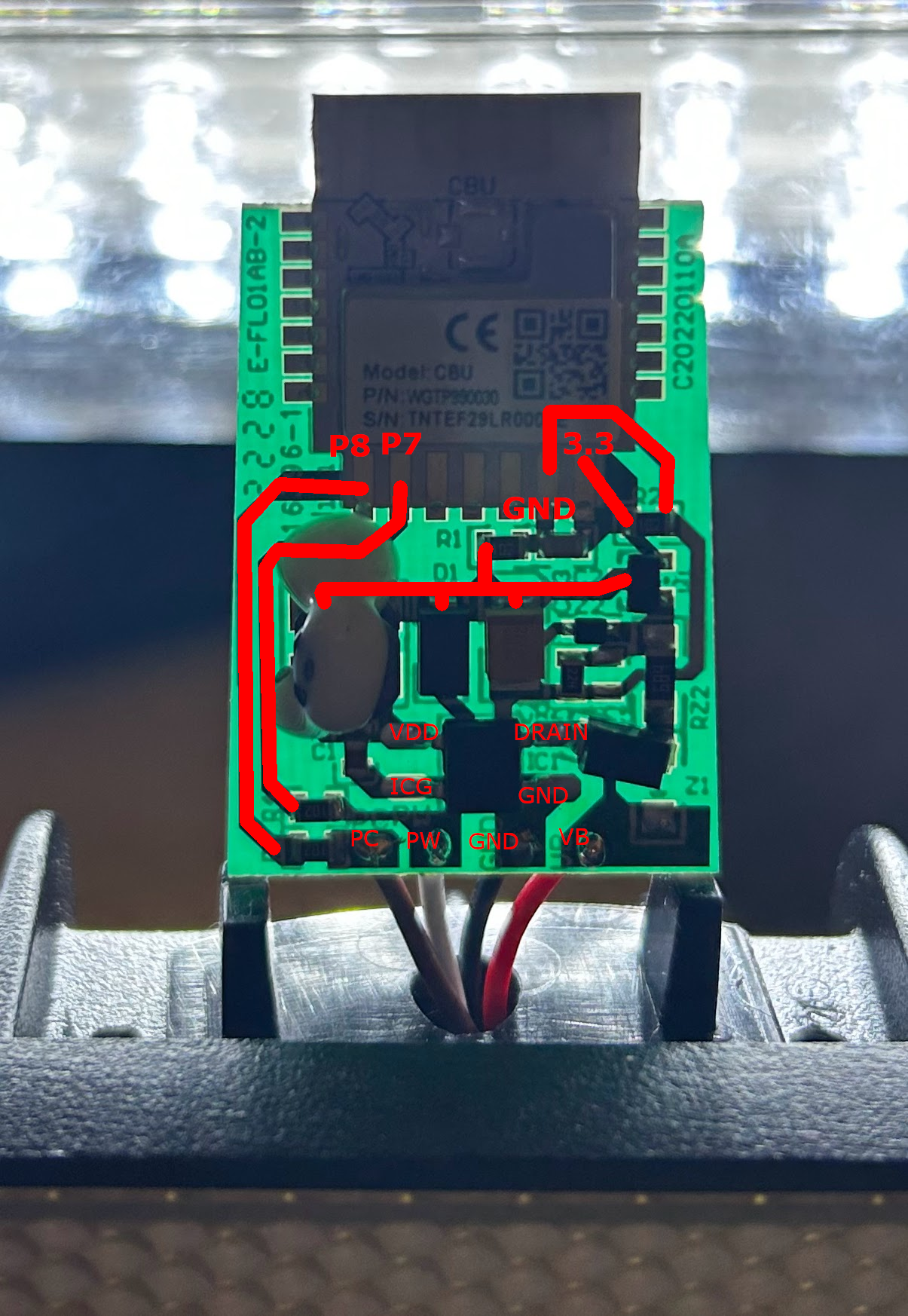 The backlit board with the P7, P8, 3.3v and GND traces marked in red