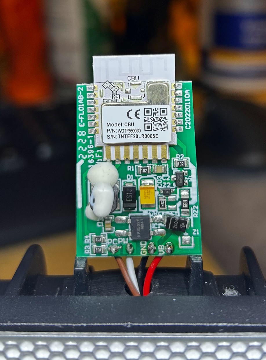 The floodlight’s control board, with the Tuya CBU module at the top